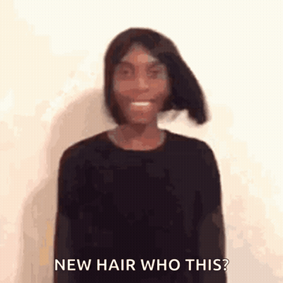 A Woman Is Wearing A Black Shirt And Smiling With The Words `` New Hair Who This ? '' Behind Her . GIF
