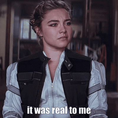 A Woman Is Wearing A Black Vest And A White Shirt And Says It Was Real To Me GIF