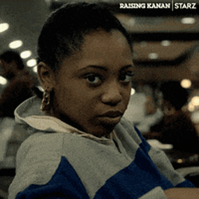 A Woman Is Wearing A Blue And Gray Striped Sweatshirt With The Word Starz On The Bottom Right GIF