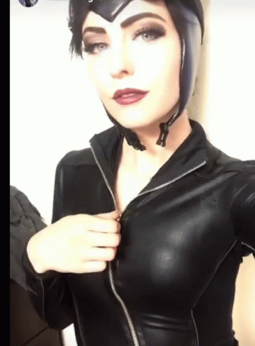 A Woman Is Wearing A Catwoman Costume And Taking A Selfie GIF