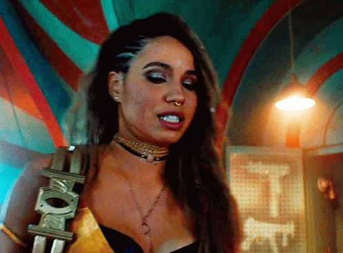 A Woman Is Wearing A Choker And A Belt With The Letter E On It GIF