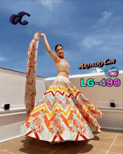 A Woman Is Wearing A Colorful Skirt And A Crop Top That Says Artistry Gin Lg-490 GIF