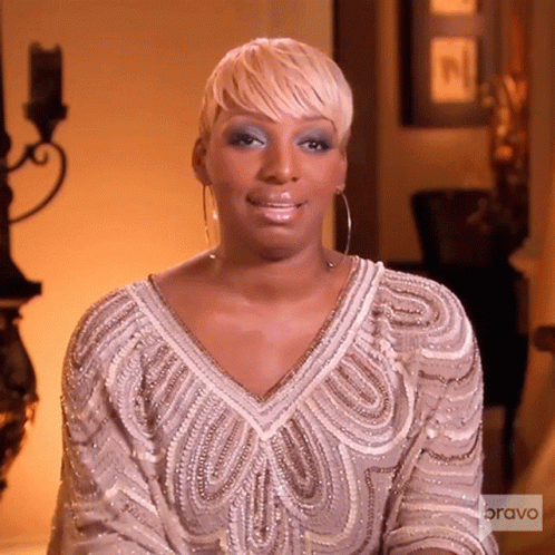 A Woman Is Wearing A Dress That Says Bravo On The Sleeve GIF