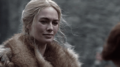 A Woman Is Wearing A Fur Coat And Looking At Something GIF