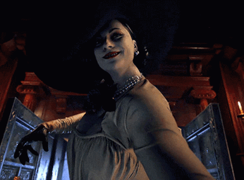 A Woman Is Wearing A Large Hat And Holding A Knife GIF
