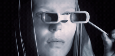 A Woman Is Wearing A Pair Of Sunglasses That Have A Hole In Them GIF
