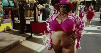 A Woman Is Wearing A Pink Bikini Top And A Pink Hat . GIF