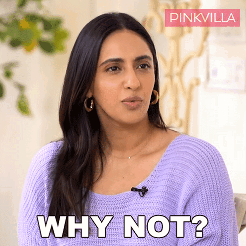 A Woman Is Wearing A Purple Sweater And Says Why Not GIF