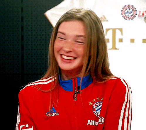 A Woman Is Wearing A Red Adidas Jacket GIF