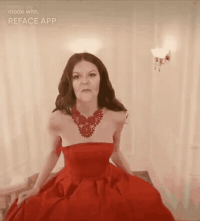 A Woman Is Wearing A Red Dress And A Red Necklace GIF