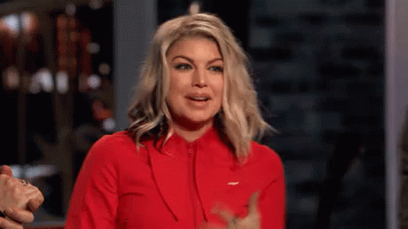 A Woman Is Wearing A Red Jacket And Giving A Thumbs Up Sign . GIF