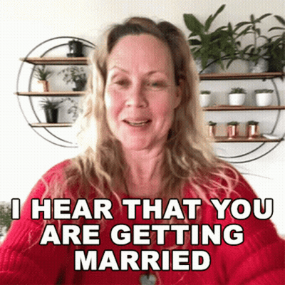 A Woman Is Wearing A Red Sweater And Says I Hear That You Are Getting Married GIF