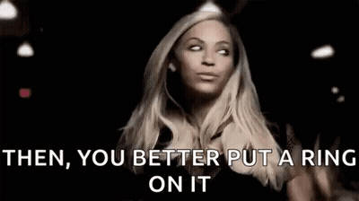 A Woman Is Wearing A Ring On Her Finger And Making A Funny Face . GIF