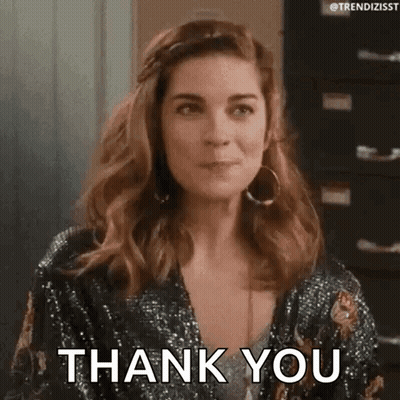 A Woman Is Wearing A Sequined Jacket And Earrings And Saying Thank You . GIF