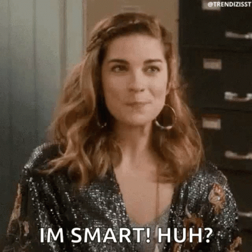 A Woman Is Wearing A Sequined Jacket And Earrings And Says `` Im Smart ! Huh ? '' . GIF