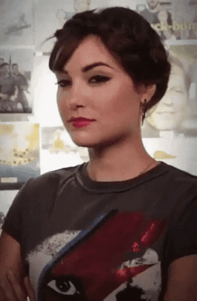 A Woman Is Wearing A T-Shirt With A Picture Of David Bowie On The Front GIF