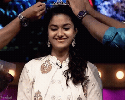A Woman Is Wearing A Tiara On Her Head GIF