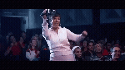 A Woman Is Wearing A Virtual Reality Headset While Dancing In Front Of A Crowd . GIF