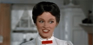 A Woman Is Wearing A White Dress And A Red Bow Tie . GIF