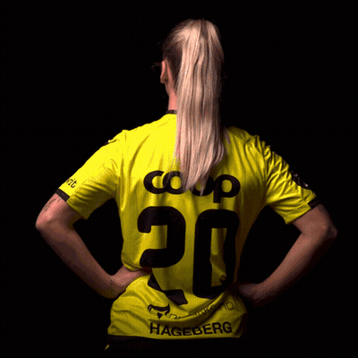 A Woman Is Wearing A Yellow Shirt With The Number 20 On The Back GIF