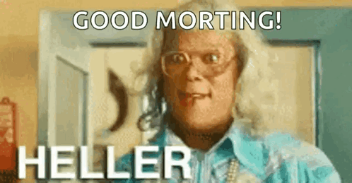A Woman Is Wearing Glasses And A Blue Shirt And Says `` Good Morning Heller '' . GIF