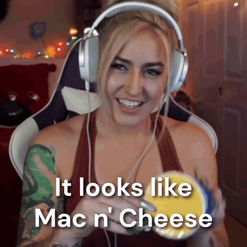 A Woman Is Wearing Headphones And Holding A Bowl Of Mac N Cheese GIF