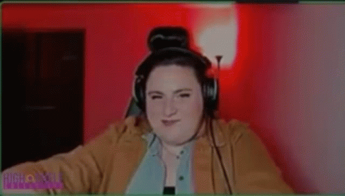 A Woman Is Wearing Headphones And Says She 'S Out For Blood . GIF