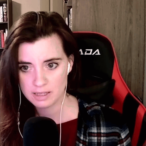 A Woman Is Wearing Headphones And Sitting In A Chair That Says Vcl On It GIF