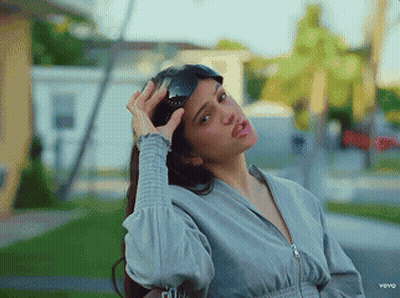 A Woman Is Wearing Sunglasses And Making A Funny Face In A Video For Vevo GIF