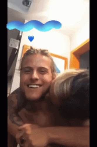 Woman Kissing Man On Cheek In Room GIF