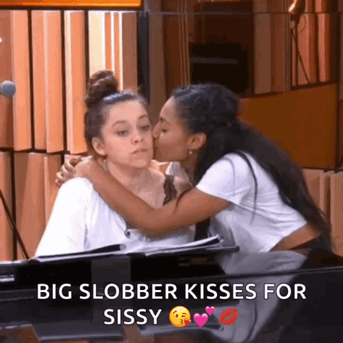 A Woman Kissing Another Woman On The Cheek With The Words Big Slobber Kisses For Sissy GIF