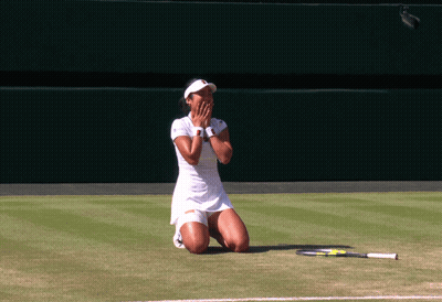 A Woman Kneeling On A Tennis Court With A Racket On The Ground GIF