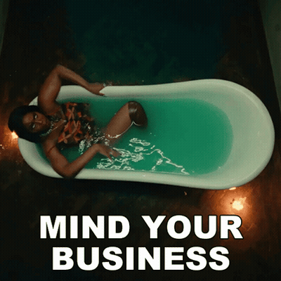 A Woman Laying In A Bathtub With The Words Mind Your Business Above Her GIF
