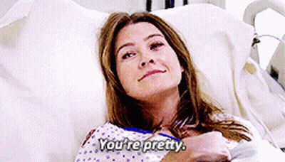 A Woman Laying In A Hospital Bed With The Words You 'Re Pretty Above Her GIF