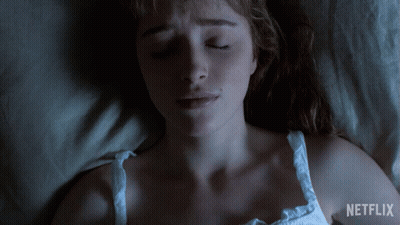 A Woman Laying In Bed With Her Eyes Closed And A Netflix Logo On The Bottom GIF