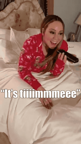 A Woman Laying On A Bed With The Words " It 'S Tiiiimmmeee " Written On The Bottom GIF
