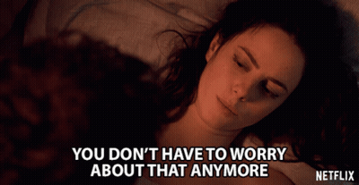 A Woman Laying On A Bed With The Words " You Don T Have To Worry About That Anymore " GIF