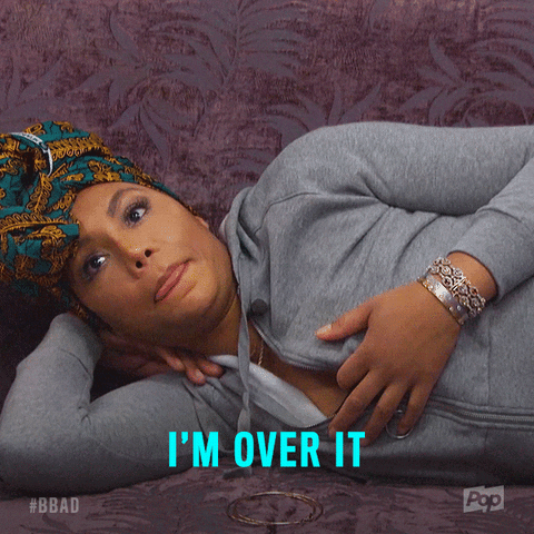 A Woman Laying On A Couch With The Words I 'M Over It Written On The Bottom GIF