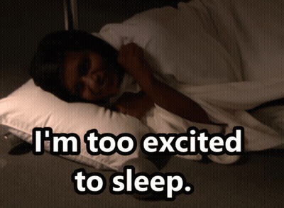 A Woman Laying On A Pillow With The Words " I 'M Too Excited To Sleep " Above Her GIF