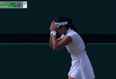 A Woman Laying On A Tennis Court With A Towel Around Her Head GIF