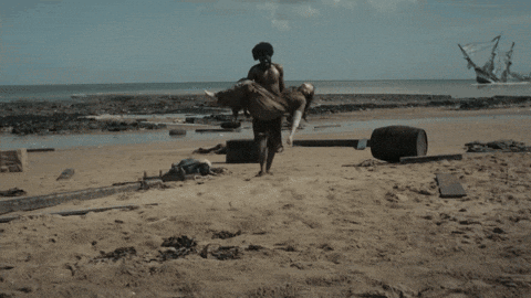 A Woman Laying On The Beach With The Words Our Heroine Was A Stowaway Carried To Shore By Another Survivor Visible GIF