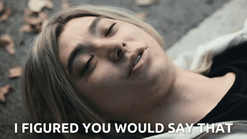 A Woman Laying On The Ground With The Words " I Figured You Would Say That " Below Her GIF