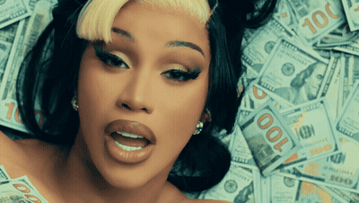 A Woman Laying On Top Of A Pile Of 100 Dollar Bills GIF