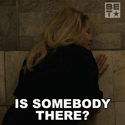 A Woman Leaning Against A Wall With The Words Is Somebody There Below Her GIF