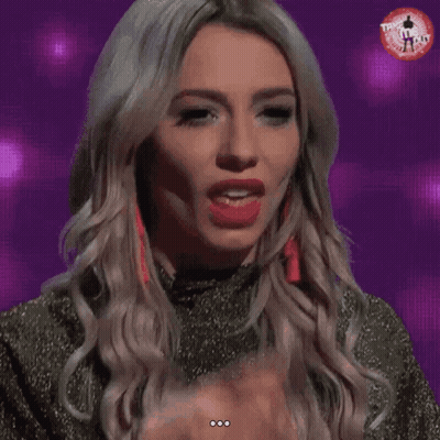 A Woman Licks Her Finger While Wearing A T-Shirt That Says ' T-Shirt ' On It GIF