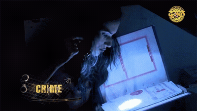 A Woman Looking At A Book With The Word Crime On The Bottom GIF