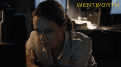A Woman Looking At A Computer Screen With The Word Wentworth On The Bottom Right GIF