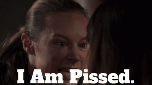 A Woman Looking At Another Woman With The Words I Am Pissed GIF