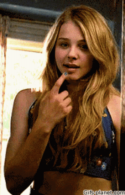 A Woman Looking At Herself In A Mirror With Gifs-Planet.com At The Bottom Of The Image GIF