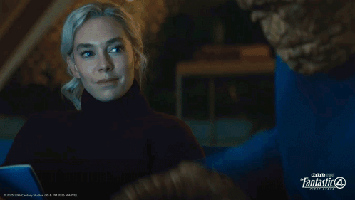 A Woman Looks At A Man In A Blue Shirt That Says Fantastic Four GIF